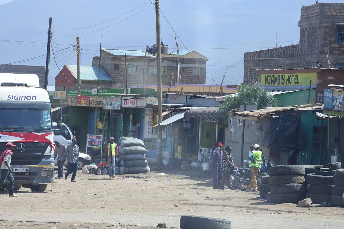 Shops and parked trucks along the main road in Naivasha town