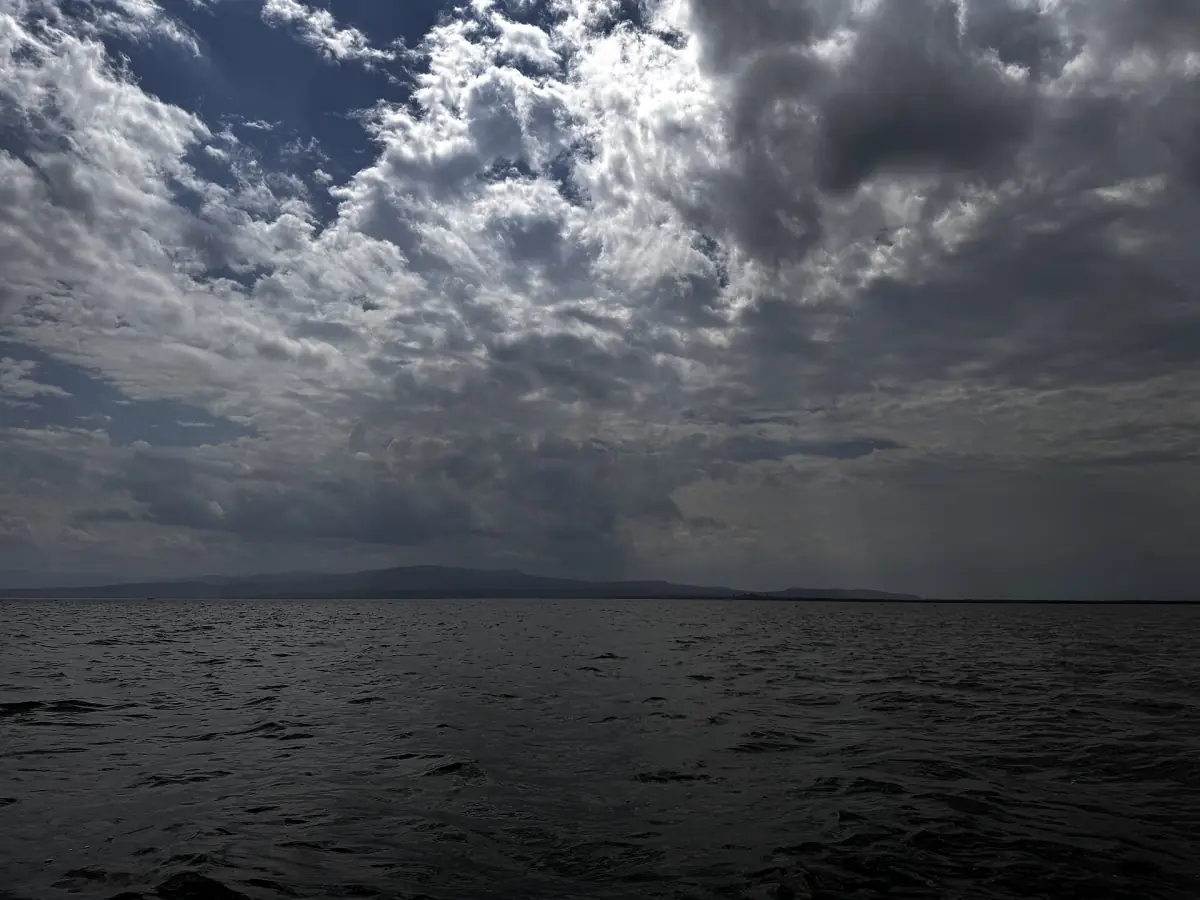 Dark rain clouds gathering over the open water of Lake Naivasha